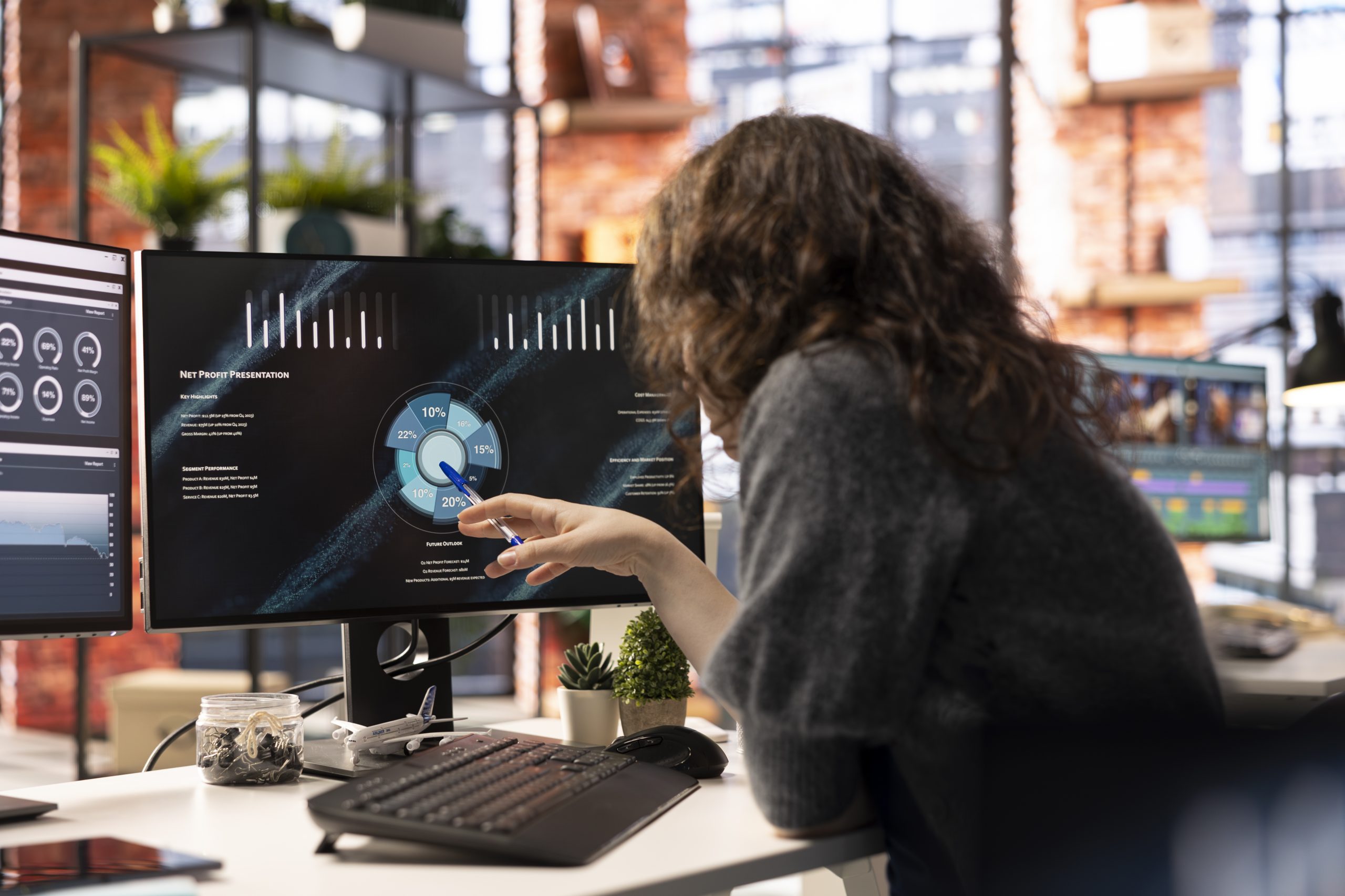 Analyst looking at presentation charts and dashboard to implement analytics