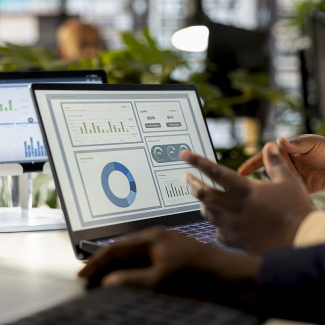 Business analyst meeting with a coworker to review financial report