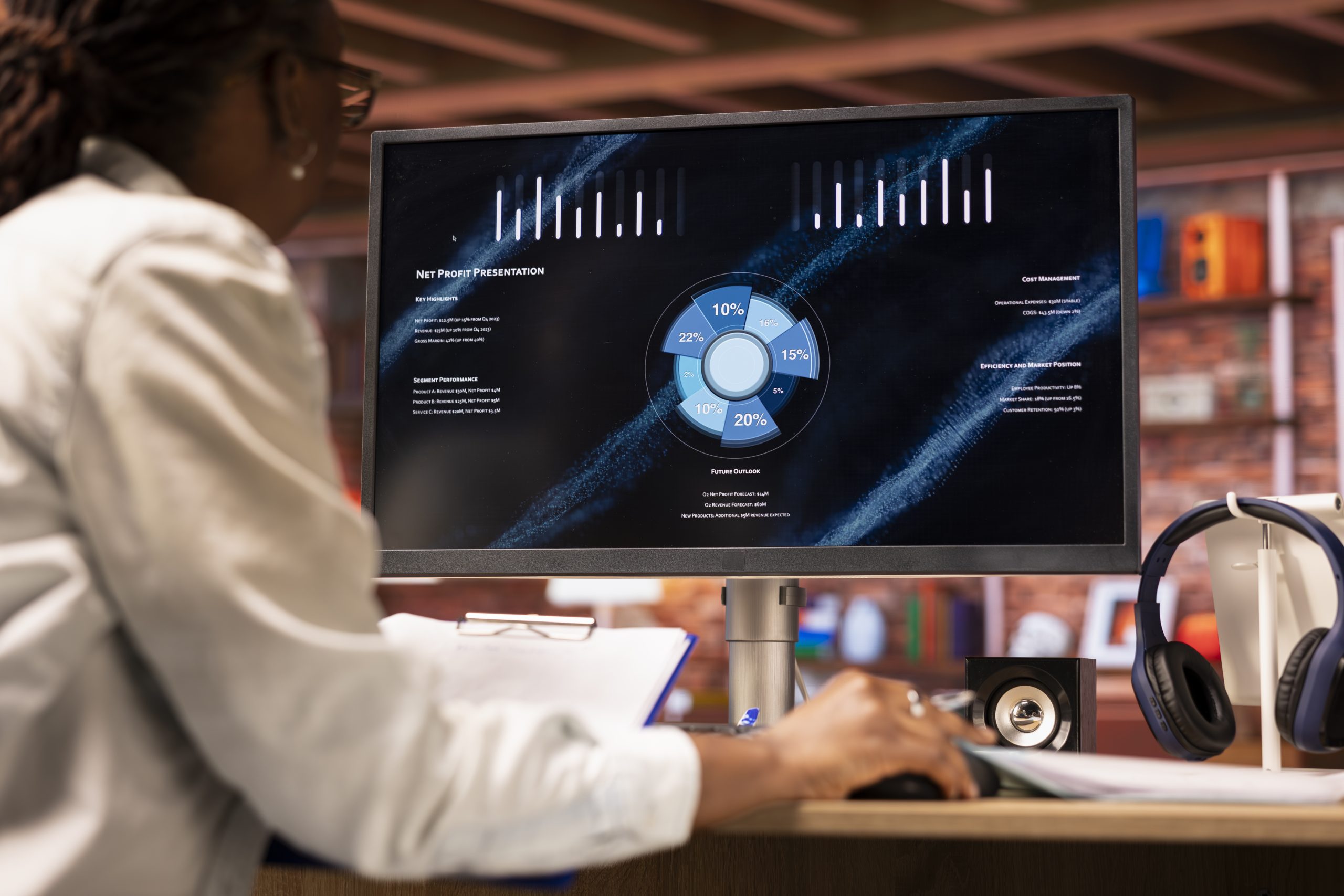 Woman watching business conference on computer screen, looking over statistics